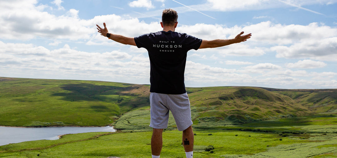 Man stands upon rock ledge 