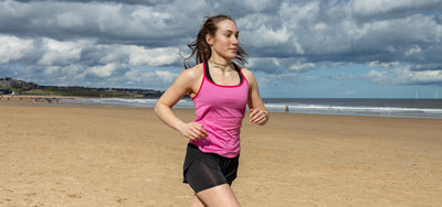 Athlete runs along beach