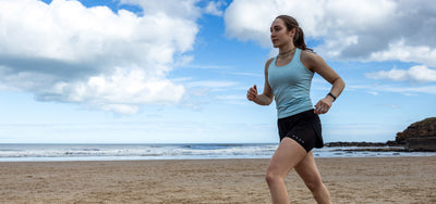 Athlete runs along beach
